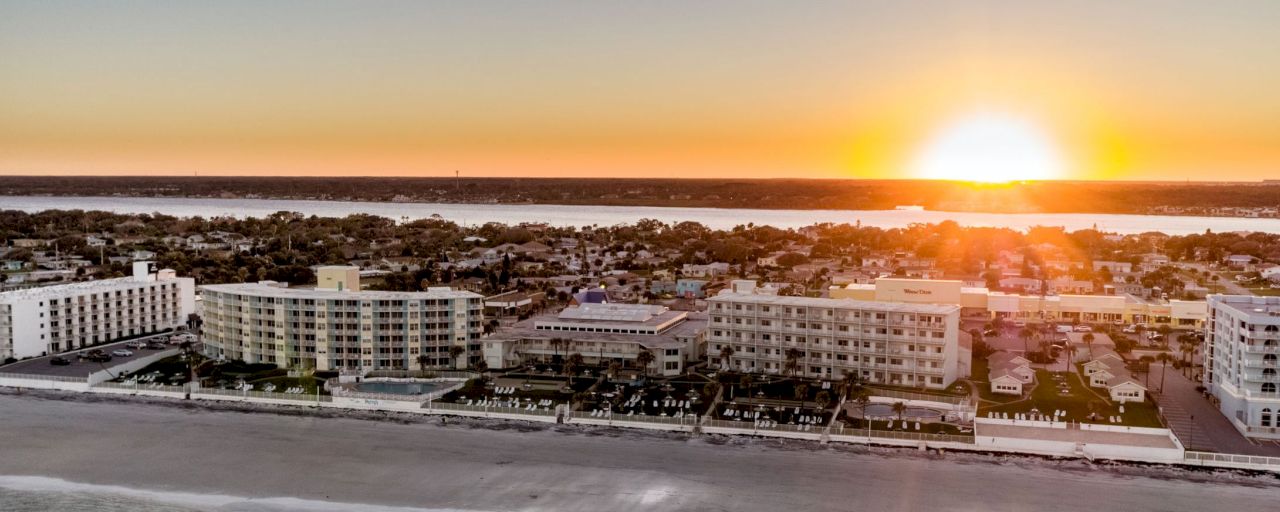 An aerial view of a beachfront resort at sunset.