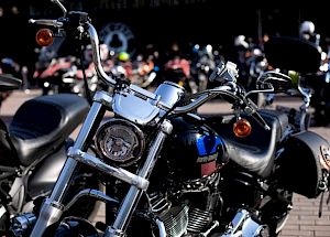 Several motorcycles are parked close together, with the focus on a shiny chrome bike in the foreground.